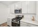 Modern kitchen with stainless steel appliances, white cabinets, quartz countertop, and a gas range at 7834 Hillway Dr, Camby, IN 46113