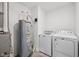 Laundry room with tile flooring, washer, dryer, and a water heater at 7834 Hillway Dr, Camby, IN 46113