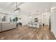 Open-concept living area featuring wood floors, recessed lighting, and seamless flow to the kitchen at 7834 Hillway Dr, Camby, IN 46113