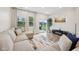 Bright living room with a large sectional sofa, neutral rug, and sliding doors to the backyard at 7834 Hillway Dr, Camby, IN 46113