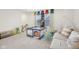 Carpeted living room with a play area and light colored couch at 7834 Hillway Dr, Camby, IN 46113