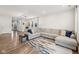 Spacious living room with a large sectional sofa, stylish rug, and view into other rooms at 7834 Hillway Dr, Camby, IN 46113