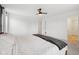 Bright bedroom with a ceiling fan, featuring white linens and a dark gray throw blanket at 7834 Hillway Dr, Camby, IN 46113