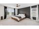 Bright main bedroom with high ceilings, large windows, a ceiling fan, and modern decor at 7834 Hillway Dr, Camby, IN 46113
