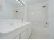 Well-lit bathroom featuring a bathtub-shower combo and vanity with clean white tiling and neutral accents at 8022 Hoover Ln, Indianapolis, IN 46260