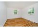 Inviting bedroom featuring hardwood floors, neutral walls, and natural light through the windows at 8022 Hoover Ln, Indianapolis, IN 46260