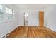 Bright bedroom featuring hardwood floors and neutral walls; note the adjacent bathroom and closet at 8022 Hoover Ln, Indianapolis, IN 46260