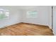 Bright bedroom featuring natural light, hardwood floors, and neutral walls at 8022 Hoover Ln, Indianapolis, IN 46260