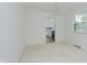 Light-filled dining room with carpet and views into the kitchen at 8022 Hoover Ln, Indianapolis, IN 46260