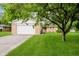 Charming single-story home with an attached garage and lush green lawn at 8022 Hoover Ln, Indianapolis, IN 46260