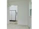 View of kitchen with white cabinets, appliances, and hardwood flooring from adjacent room at 8022 Hoover Ln, Indianapolis, IN 46260