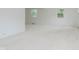 Spacious living room featuring neutral carpeting and plenty of natural light through the windows at 8022 Hoover Ln, Indianapolis, IN 46260