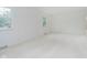 Bright living room with white walls, plush carpeting, and natural light from large windows at 8022 Hoover Ln, Indianapolis, IN 46260