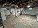 Spacious basement featuring painted walls, exposed ceiling, utility sink and washer and dryer at 810 N Bosart Ave, Indianapolis, IN 46201