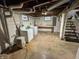 Basement featuring painted walls, exposed ceiling, utility sink and washer and dryer at 810 N Bosart Ave, Indianapolis, IN 46201