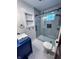 Modern bathroom featuring a glass shower door, stylish tiling, and a navy vanity at 810 N Bosart Ave, Indianapolis, IN 46201