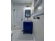 Bathroom boasting a modern navy vanity with hexagon-tiled floors, and updated lighting at 810 N Bosart Ave, Indianapolis, IN 46201
