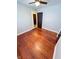 Bedroom featuring hardwood floors, ceiling fan, dark trim door and gray colored walls at 810 N Bosart Ave, Indianapolis, IN 46201
