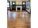 Cozy living room with hardwood floors and a striking fireplace at 810 N Bosart Ave, Indianapolis, IN 46201