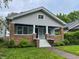 Charming home with a cozy front porch, brick accents, and a well-maintained lawn at 810 N Bosart Ave, Indianapolis, IN 46201