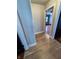 View of a hallway featuring new hardwood floors and neutral-toned walls, creating a seamless flow between rooms at 810 N Bosart Ave, Indianapolis, IN 46201
