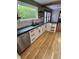Modern kitchen with hardwood floors, stainless appliances, and lots of natural light at 810 N Bosart Ave, Indianapolis, IN 46201