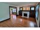 Bright living room boasting wood floors, fireplace, and decorative stained trim at 810 N Bosart Ave, Indianapolis, IN 46201