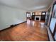 Spacious living room with hardwood floors, a fireplace, and natural light at 810 N Bosart Ave, Indianapolis, IN 46201