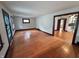 Open-concept living room showcasing hardwood floors, stained trim, and neutral walls at 810 N Bosart Ave, Indianapolis, IN 46201