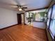 Living room with hardwood floors opening to an updated kitchen with a breakfast bar at 810 N Bosart Ave, Indianapolis, IN 46201