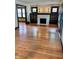 Open living room featuring natural light, hardwood floors, and entry into the kitchen at 810 N Bosart Ave, Indianapolis, IN 46201