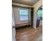 Cozy mudroom features built-in bench with storage, complemented by hardwood floors and open access to the kitchen at 810 N Bosart Ave, Indianapolis, IN 46201