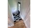 Stairwell with freshly painted walls, hardwood flooring and decorative black and white tiles at 810 N Bosart Ave, Indianapolis, IN 46201