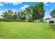 Expansive backyard featuring a lush green lawn, mature trees, and ample space for outdoor activities at 818 Vasbinder Dr, Chesterfield, IN 46017