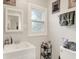 Bright bathroom featuring a modern vanity, frosted window, and stylish accessories at 818 Vasbinder Dr, Chesterfield, IN 46017