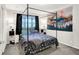 Serene bedroom with a cozy bed, mountain wall art, and soft natural lighting at 818 Vasbinder Dr, Chesterfield, IN 46017