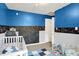 Bright Bedroom with playful chalkboard wall, carpeted floors, and a calming, cozy ambiance at 818 Vasbinder Dr, Chesterfield, IN 46017