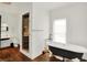Bright bathroom with a black and white clawfoot tub, shower, sink and window at 838 Woodruff Place West Dr, Indianapolis, IN 46201