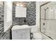 Modern bathroom with a tile accent wall, sleek vanity, and glass-enclosed shower at 838 Woodruff Place West Dr, Indianapolis, IN 46201