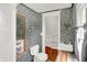 Modern bathroom design with mosaic tile, white fixtures, and natural wood accents for a stylish look at 838 Woodruff Place West Dr, Indianapolis, IN 46201