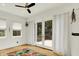 Bright bedroom featuring hardwood floors, white walls, and a sliding door to the outside deck at 838 Woodruff Place West Dr, Indianapolis, IN 46201