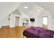 Spacious bedroom featuring light-colored walls, hardwood floors, and a glimpse into a small kitchen space at 838 Woodruff Place West Dr, Indianapolis, IN 46201