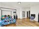 Spacious bedroom featuring hardwood floors, a four poster bed, and plenty of natural light at 838 Woodruff Place West Dr, Indianapolis, IN 46201