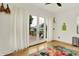 Bedroom featuring hardwood floors, white walls, and a sliding door to a wooden outside deck at 838 Woodruff Place West Dr, Indianapolis, IN 46201