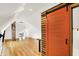 Lofted bonus room with light wood floors, bright white walls, an orange sliding door and natural light at 838 Woodruff Place West Dr, Indianapolis, IN 46201
