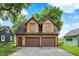 Inviting exterior view of a two-story garage building with ample parking and attractive curb appeal at 838 Woodruff Place West Dr, Indianapolis, IN 46201