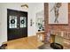 Welcoming foyer with hardwood floors, brick fireplace, and double doors at 838 Woodruff Place West Dr, Indianapolis, IN 46201