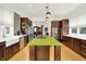 Spacious kitchen with stainless steel appliances, dark wood cabinetry, a cooktop island, and modern fixtures at 838 Woodruff Place West Dr, Indianapolis, IN 46201