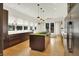A modern kitchen featuring stainless steel appliances, stylish lighting, and a large central island with a cooktop at 838 Woodruff Place West Dr, Indianapolis, IN 46201