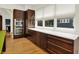 Modern kitchen featuring stainless steel appliances and dark wood cabinets with sleek hardware at 838 Woodruff Place West Dr, Indianapolis, IN 46201